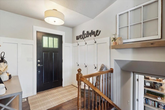 1184 Bridgecreek Ln, Layton, UT 84041 - foyer featuring dark wood-style flooring and wainscoting