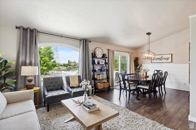 1184 Bridgecreek Ln, Layton, UT 84041 - living area with dark wood-style flooring, a chandelier, lofted ceiling, and wainscoting