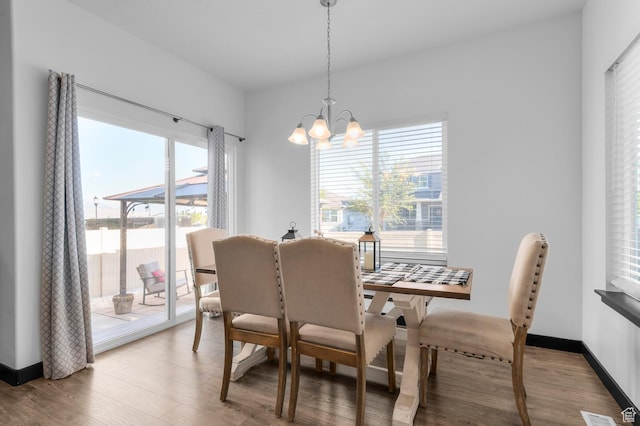 5631 W Still Well Ln S, Herriman, UT 84096 - dining area with a chandelier, healthy amount of natural light, and wood finished floors