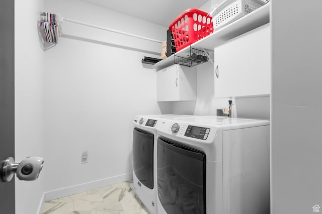 5631 W Still Well Ln S, Herriman, UT 84096 - washroom featuring washing machine and dryer, cabinet space, and light marble finish floors