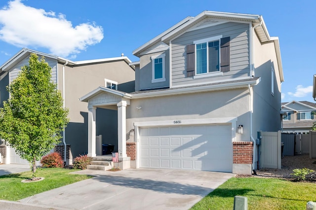 5631 W Still Well Ln S, Herriman, UT 84096 - traditional-style house with an attached garage, brick siding, stucco siding, and concrete driveway