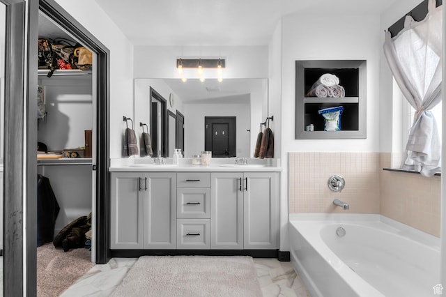 5631 W Still Well Ln S, Herriman, UT 84096 - bathroom featuring marble look tiles, double vanity, and a bath