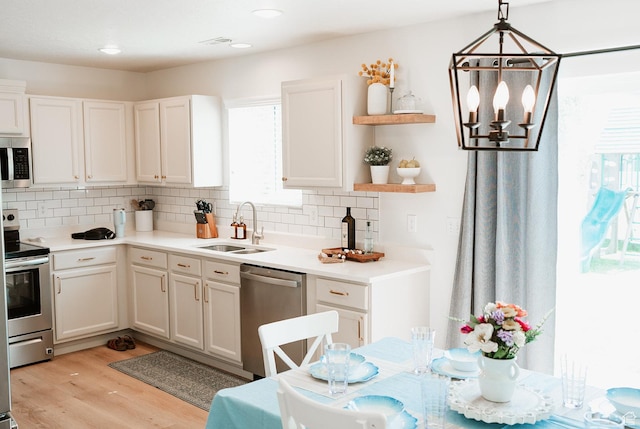 279 S 950 W, Spanish Fork, UT 84660 - kitchen featuring stainless steel appliances, backsplash, white cabinets, open shelves, and light wood-style floors