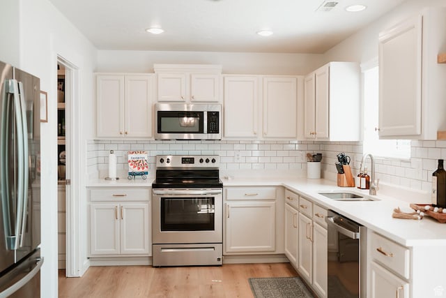 279 S 950 W, Spanish Fork, UT 84660 - kitchen with appliances with stainless steel finishes, healthy amount of natural light, light countertops, light wood-type flooring, and recessed lighting