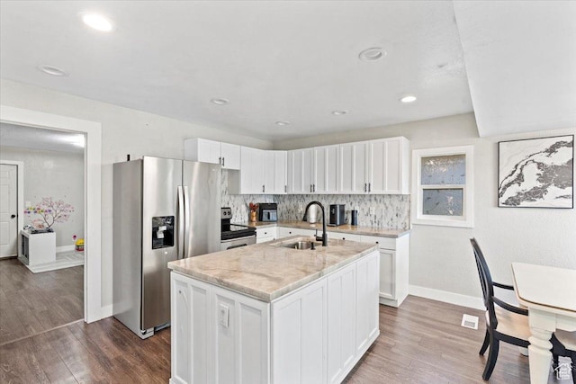 96 S 1000 W, Orem, UT 84058 - kitchen featuring appliances with stainless steel finishes, white cabinetry, dark wood finished floors, a kitchen island with sink, and tasteful backsplash