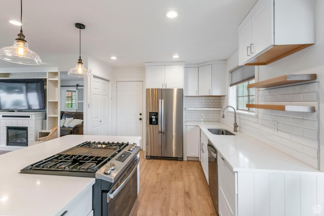 249 N 800 W, Orem, UT 84057 - kitchen featuring appliances with stainless steel finishes, light countertops, white cabinetry, light wood finished floors, and recessed lighting