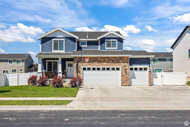 1098 S 4050 W, Syracuse, UT 84075 - view of front of home featuring covered porch, concrete driveway, stone siding, a garage, and a gate