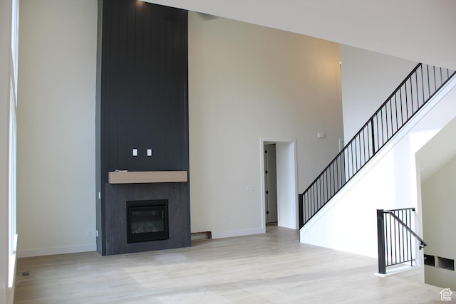1318 S 1090 E, Salem, UT 84653 - unfurnished living room with a high ceiling, wood finished floors, stairway, and a fireplace