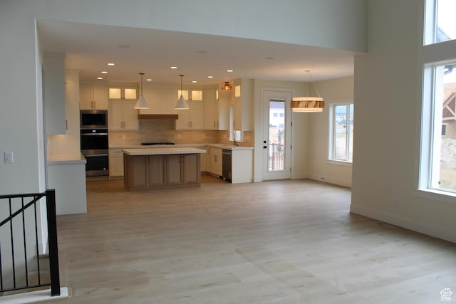 1318 S 1090 E, Salem, UT 84653 - kitchen featuring appliances with stainless steel finishes, light countertops, glass insert cabinets, backsplash, and open floor plan