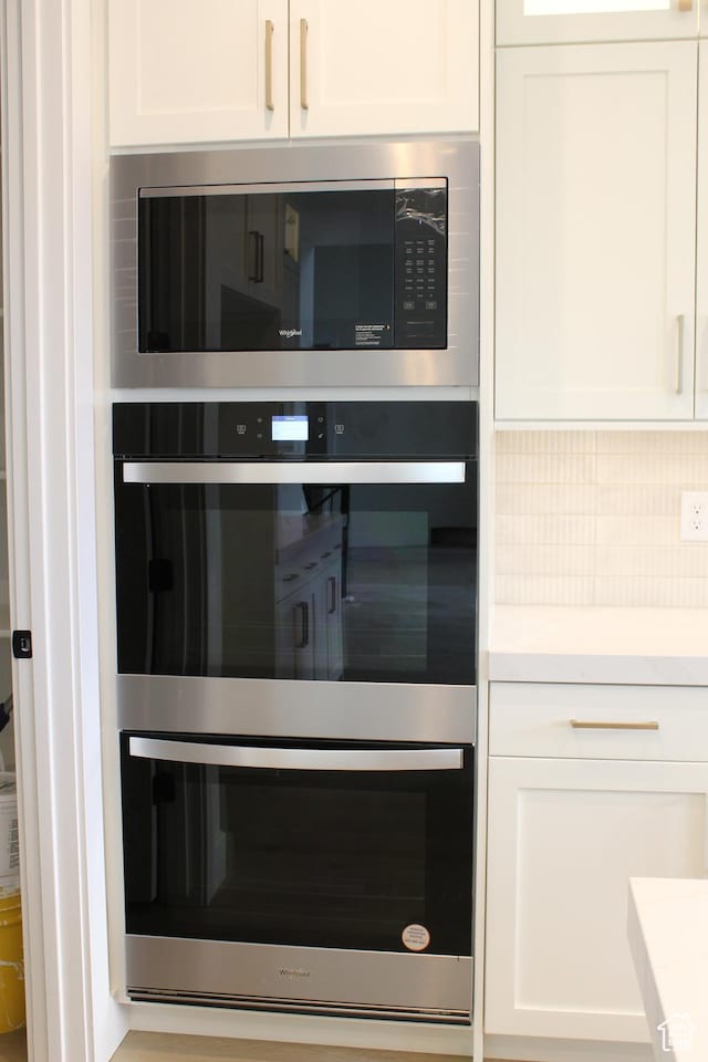 1318 S 1090 E, Salem, UT 84653 - kitchen view of appliances with stainless steel finishes, white cabinetry, tasteful backsplash, and light countertops