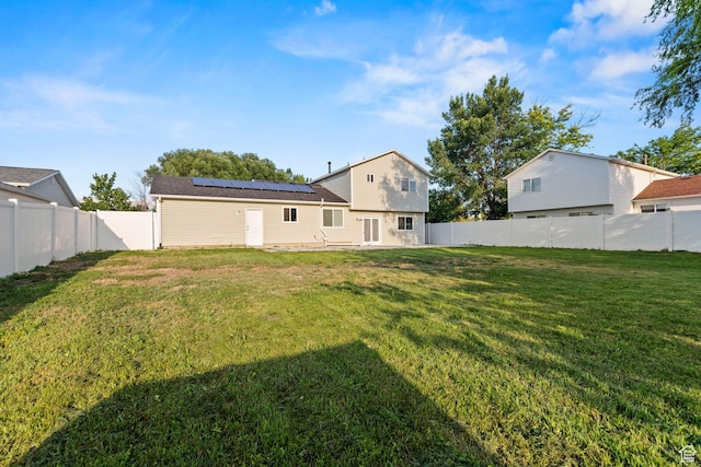 616 S 1430 W, Lehi, UT 84043 - rear view of property featuring roof mounted solar panels, a fenced backyard, and a patio