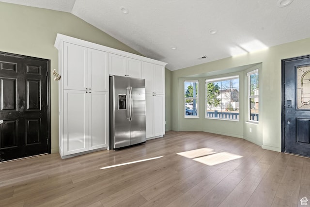 616 S 1430 W, Lehi, UT 84043 - kitchen featuring stainless steel refrigerator with ice dispenser, vaulted ceiling, white cabinets, and light wood finished floors