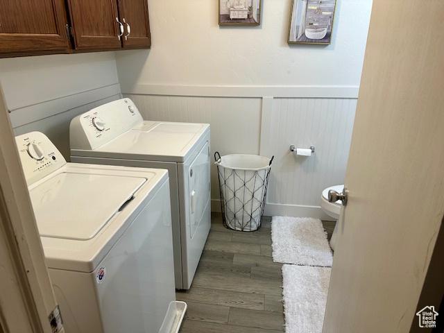 1200 N 100 W Unit 40, Vernal, UT 84078 - laundry room with separate washer and dryer, a wainscoted wall, wood finished floors, and cabinet space