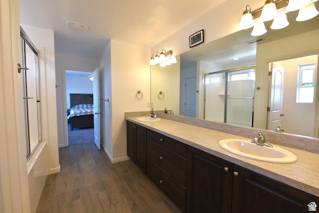4666 W Olympic Wood Ct, West Jordan, UT 84084 - full bath featuring a shower with door, double vanity, wood finished floors, and connected bathroom