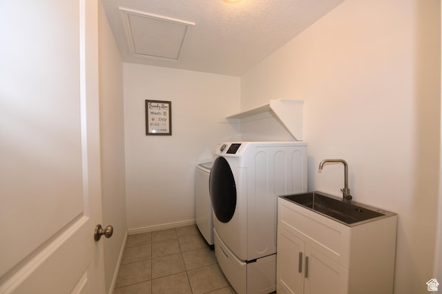 4666 W Olympic Wood Ct, West Jordan, UT 84084 - laundry area with washer and clothes dryer, light tile patterned flooring, a textured ceiling, and cabinet space