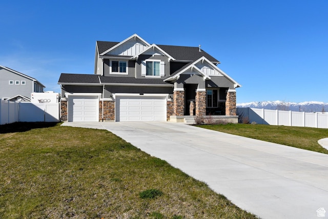 4666 W Olympic Wood Ct, West Jordan, UT 84084 - craftsman house featuring stone siding, an attached garage, driveway, a mountain view, and stucco siding