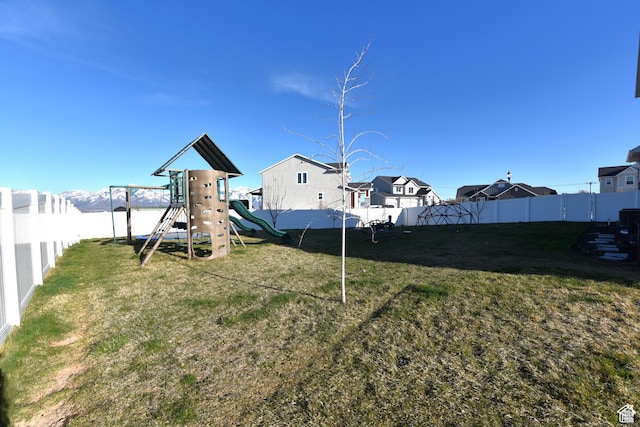 4666 W Olympic Wood Ct, West Jordan, UT 84084 - fenced backyard featuring a playground and a residential view