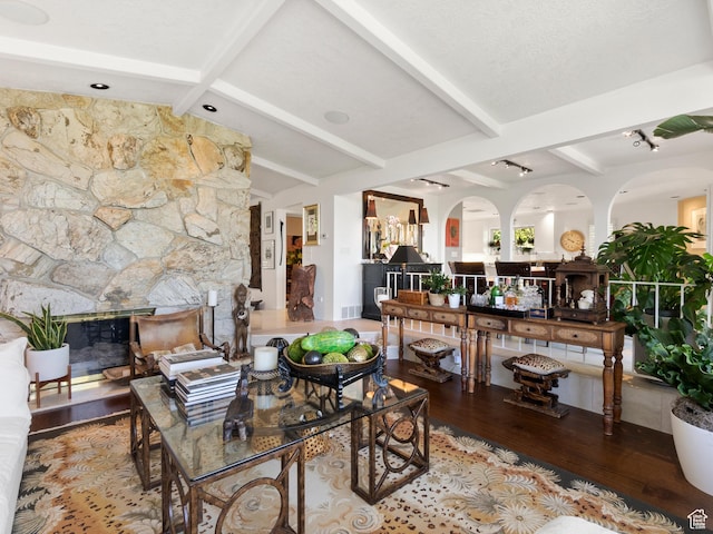 4506 S Gilead Way E, Millcreek, UT 84124 - living room featuring wood finished floors, arched walkways, and a fireplace