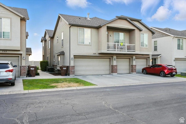 729 N Buckingham Dr W, North Salt Lake, UT 84054 - townhome / multi-family property with brick siding, an attached garage, stucco siding, and driveway