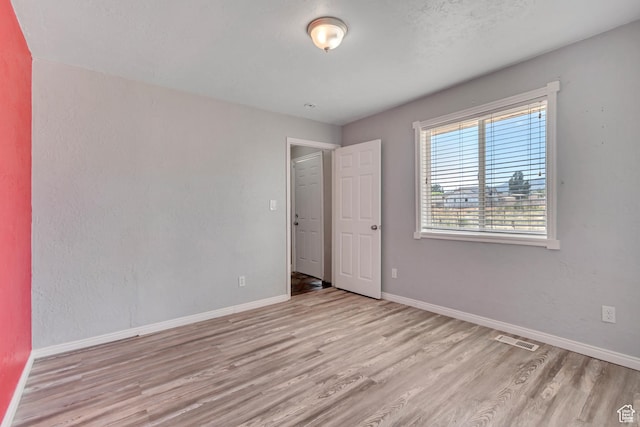 9517 N Shiloh Way E, Eagle Mountain, UT 84005 - spare room featuring wood finished floors and baseboards