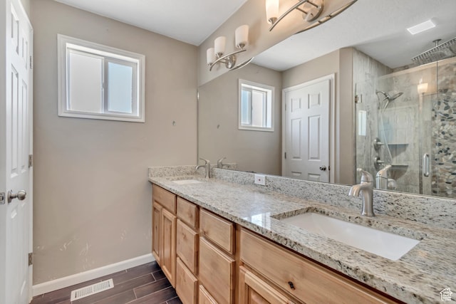 9517 N Shiloh Way E, Eagle Mountain, UT 84005 - bathroom with a stall shower, double vanity, and wood finished floors