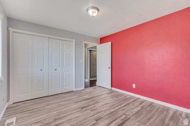 9517 N Shiloh Way E, Eagle Mountain, UT 84005 - unfurnished bedroom featuring wood finished floors and a closet