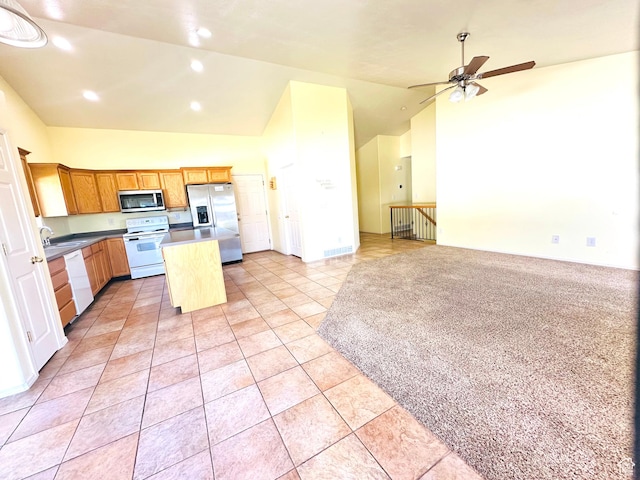 2592 W 2650 N, Clinton, UT 84015 - kitchen featuring appliances with stainless steel finishes, lofted ceiling, a center island, open floor plan, and ceiling fan