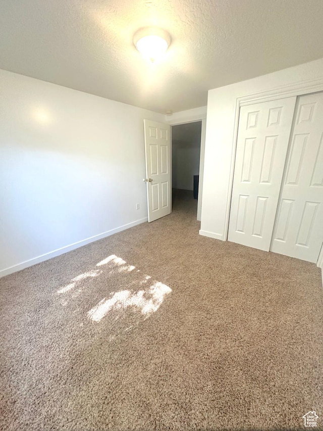 2592 W 2650 N, Clinton, UT 84015 - unfurnished bedroom featuring a closet, carpet floors, and a textured ceiling