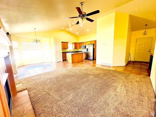 2592 W 2650 N, Clinton, UT 84015 - unfurnished living room featuring light tile patterned floors, a fireplace, vaulted ceiling, a ceiling fan, and light colored carpet
