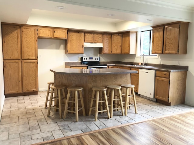 7692 S Chad St, Midvale, UT 84047 - kitchen featuring electric range, under cabinet range hood, dishwasher, brown cabinets, and dark countertops