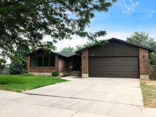 7692 S Chad St, Midvale, UT 84047 - single story home with brick siding, an attached garage, concrete driveway, and a front lawn