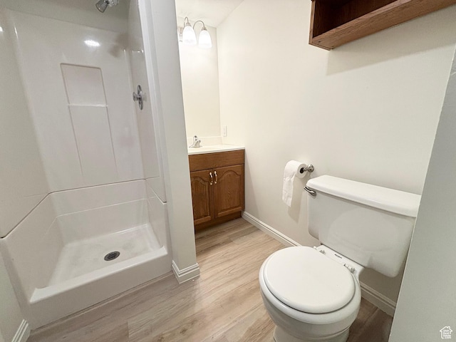 7692 S Chad St, Midvale, UT 84047 - bathroom with wood finished floors, a stall shower, and vanity