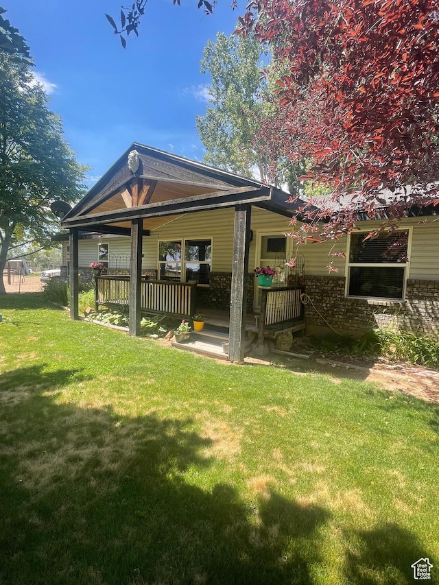 5518 E 500 N, Fort Duchesne, UT 84026 - rear view of house featuring a yard