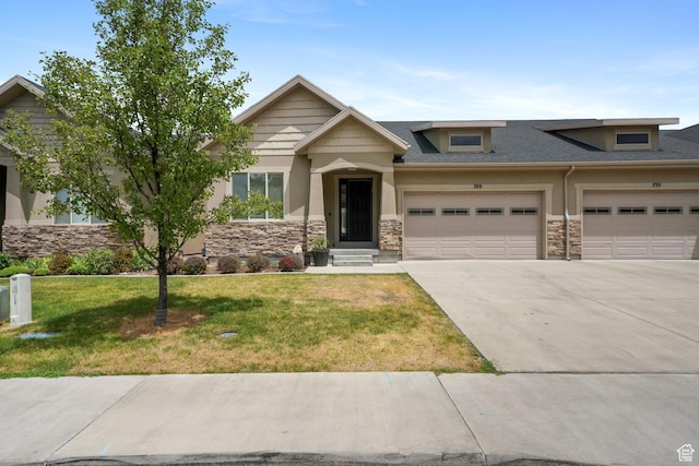 749 E 1600 S, Orem, UT 84097 - view of front facade featuring stone siding, driveway, a garage, a front lawn, and stucco siding