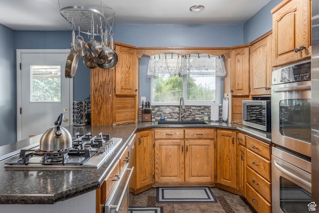 8268 S 865 E, Sandy, UT 84094 - kitchen featuring stainless steel appliances, healthy amount of natural light, a peninsula, and backsplash