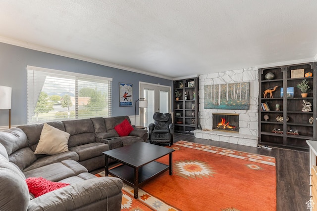 8268 S 865 E, Sandy, UT 84094 - living area featuring crown molding, wood finished floors, a textured ceiling, built in shelves, and a fireplace