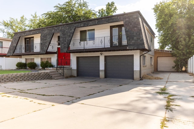 8268 S 865 E, Sandy, UT 84094 - view of front facade with brick siding, a garage, driveway, and a balcony
