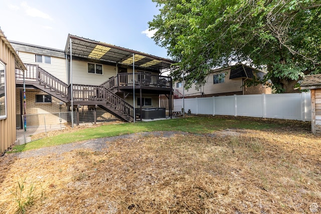 8268 S 865 E, Sandy, UT 84094 - back of property featuring a hot tub, stairs, a fenced backyard, and a deck