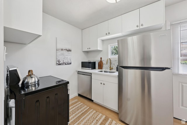140 W 1200 N, Orem, UT 84057 - kitchen featuring stainless steel appliances, white cabinetry, light countertops, and light wood-style floors