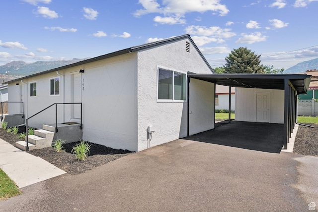 140 W 1200 N, Orem, UT 84057 - view of front of property with a mountain view, driveway, an attached carport, and stucco siding