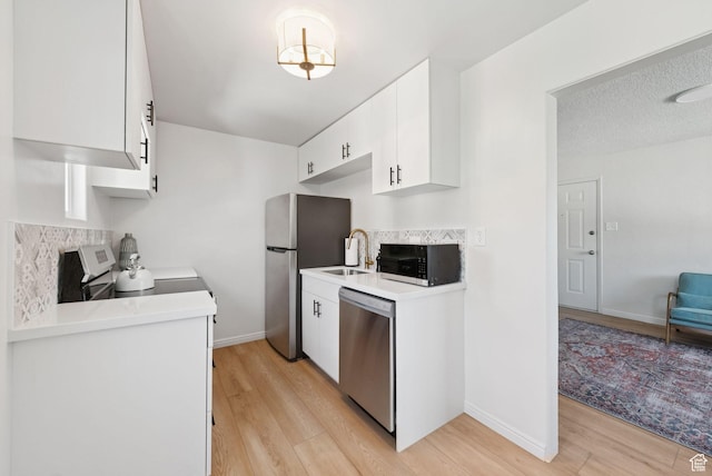 140 W 1200 N, Orem, UT 84057 - kitchen featuring appliances with stainless steel finishes, light wood finished floors, white cabinets, and light countertops