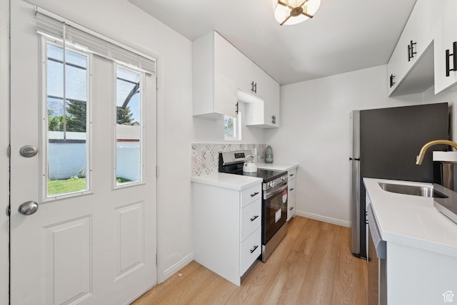 140 W 1200 N, Orem, UT 84057 - kitchen with stainless steel appliances, light wood-style floors, tasteful backsplash, white cabinets, and light countertops