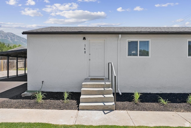 140 W 1200 N, Orem, UT 84057 - view of exterior entry featuring a mountain view, an attached carport, stucco siding, and roof with shingles