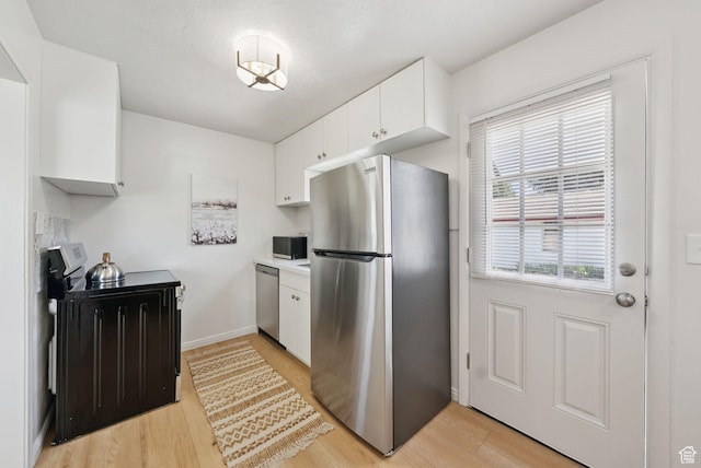 140 W 1200 N, Orem, UT 84057 - kitchen with appliances with stainless steel finishes, white cabinets, light wood-style flooring, and light countertops