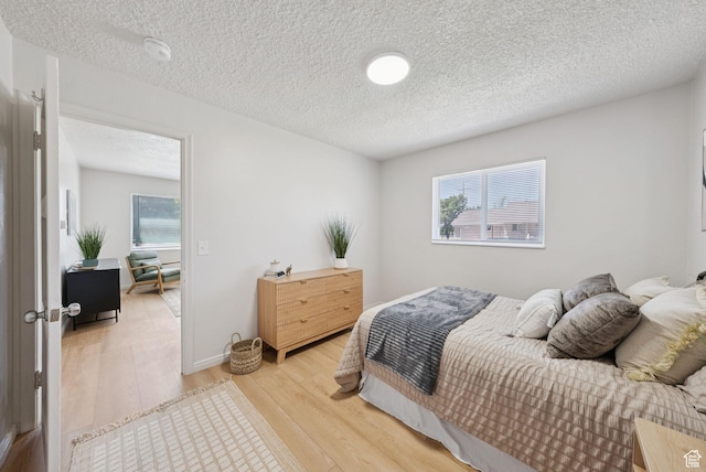 140 W 1200 N, Orem, UT 84057 - bedroom with light wood-style flooring, multiple windows, and a textured ceiling