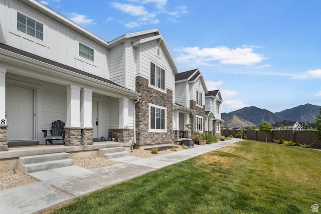 1152 S 800 W, Spanish Fork, UT 84660 - view of front of house with stone siding, covered porch, a mountain view, a residential view, and board and batten siding