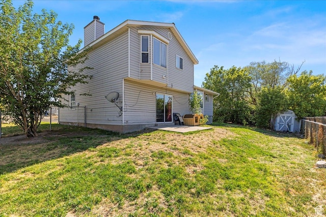 6410 W Martin Way S, West Valley City, UT 84128 - back of house featuring a storage shed, a patio, a fenced backyard, and a chimney