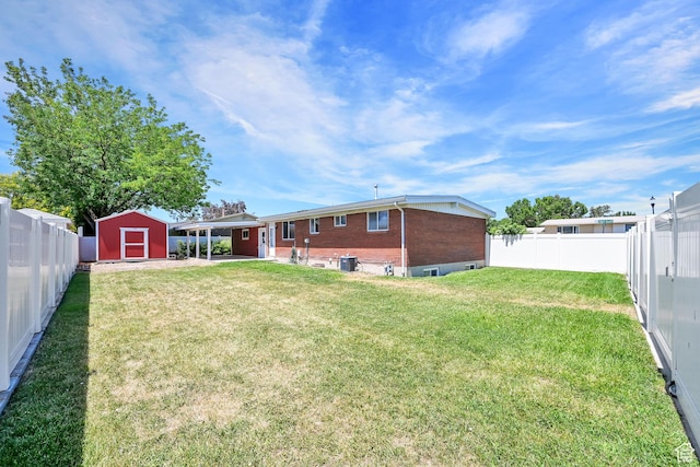 2743 W 7460 S, West Jordan, UT 84084 - rear view of property with a shed, brick siding, a fenced backyard, a carport, and a patio