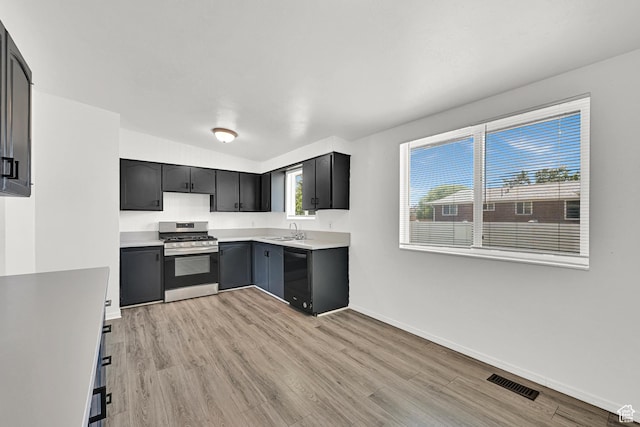 2743 W 7460 S, West Jordan, UT 84084 - kitchen with stainless steel gas range oven, dishwasher, light countertops, light wood-style flooring, and vaulted ceiling