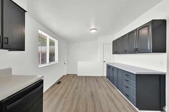 2743 W 7460 S, West Jordan, UT 84084 - kitchen featuring light wood-type flooring, light countertops, and black dishwasher